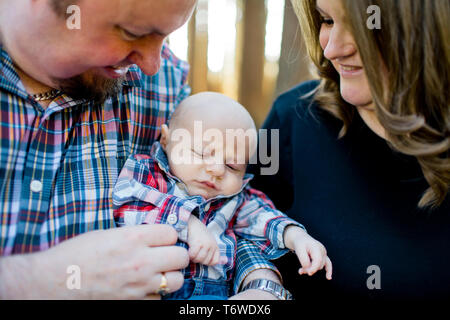 New parents hold their newborn son. Stock Photo