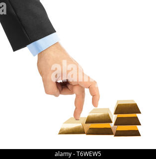 Hand and stairs made of gold bars Stock Photo