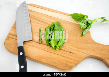 Julienned Basil Leaves on a Cutting Board Stock Photo