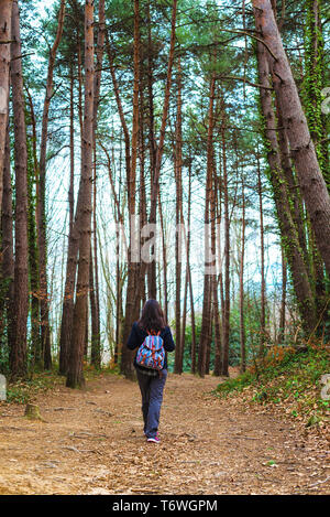 Back view of a backpacker woman hiking Stock Photo - Alamy