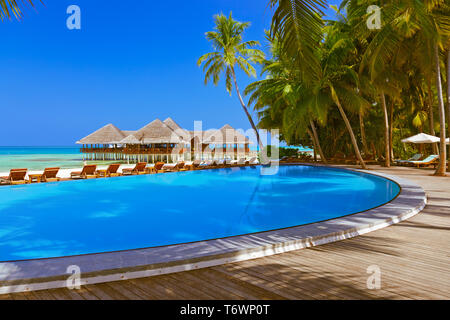 Pool and cafe on Maldives beach Stock Photo