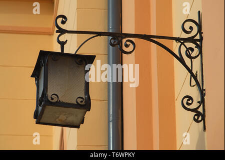 Vintage retro old style lantern on a orange wall Stock Photo