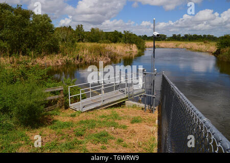 Secure Remote Location Observation Telemetry Fresh Water Lake Level Monitoring Equipment Station Gated Aluminum Walkway Chain Length Fence Florida Stock Photo