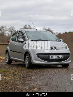 Silver Peugeot 107 city car in countryside setting Stock Photo