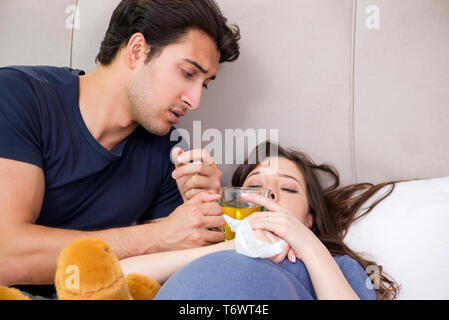 Young husband looking after his pregnant wife Stock Photo