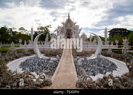 Temple highly visited by tourists in Chiang Rai, Wat Rong Khun, perhaps best known to Foreigners as the White Temple, is a contemporary, unconventiona Stock Photo