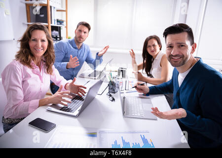 Group Of Business Executives Complaining Toward Camera In Office Stock Photo