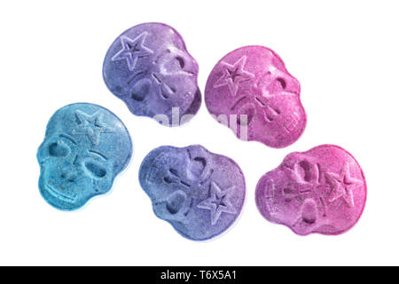 Five Blue, pink, purple army Skull, Ecstasy, MDMA, Amphetamine or medication pills shaped like a skull isolated on a white background. Stock Photo