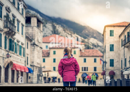 Girl in a waterproof jacket in Kotor Old Town Stock Photo