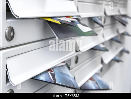 Modern mailboxes filled of flyers Stock Photo