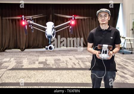 Beijing, China's Guangdong Province. 22nd May, 2015. Wang Tao, founder of Da-Jiang Innovations (DJI), controls a drone in his company in Shenzhen, south China's Guangdong Province, May 22, 2015. Credit: Mao Siqian/Xinhua/Alamy Live News Stock Photo