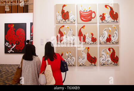 Jakarta, DKI Jakarta, Indonesia. 3rd May, 2019. Visitors are seen admiring paintings of Wenas Heriyanto artwork during the Art Moments.Art Moments Jakarta, is an art fair held on May 3 - 5 in Jakarta showcasing over 30 leading local and international galleries. The fair which was opened for the public for two days exhibiting contemporary art works from renowned artists such as Banksy, Christine Ay Tjoe, Handiwirman Saputra, Robert Indiana, Fernando Botero, Ju Ming, Kaws, Marc Quinn and Jean Mitchel Othoniel among others. Credit: Nicklas Hanoatubun/SOPA Images/ZUMA Wire/Alamy Live News Stock Photo