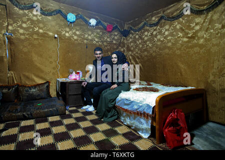 Anjar, Lebanon. 03rd May, 2019. Syrian refugee Nissreine Ali (R), 16, sits beside her husband 22 years old Ibrahim al-Abed at their wedding tent. Credit: Marwan Naamani/dpa/Alamy Live News Stock Photo