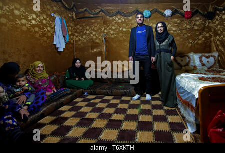 Anjar, Lebanon. 03rd May, 2019. Syrian refugee Nissreine Ali (R), 16, stands beside her husband 22 years old Ibrahim al-Abed as they receive guests at their wedding tent. Credit: Marwan Naamani/dpa/Alamy Live News Stock Photo