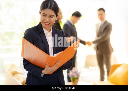 Asian Businesswoman hold working file Stock Photo