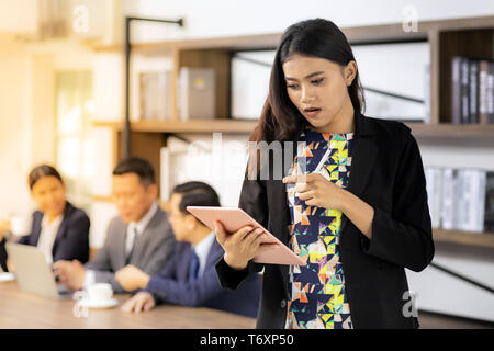 asian Businesswoman working with smart tablet Stock Photo