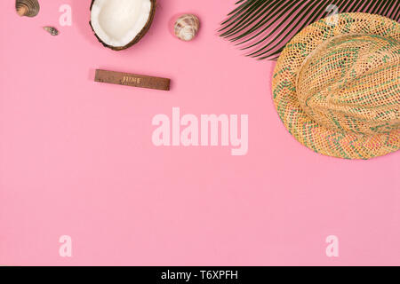 coconut, palm leaf, hat,  on a pink background, top view Stock Photo