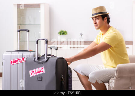 The man going on vacation with fragile suitcases Stock Photo