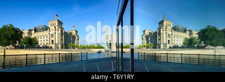 Reichstag reflected in glass facade of Marie-Elisabeth-Luders-Haus, Berlin, Germany Stock Photo