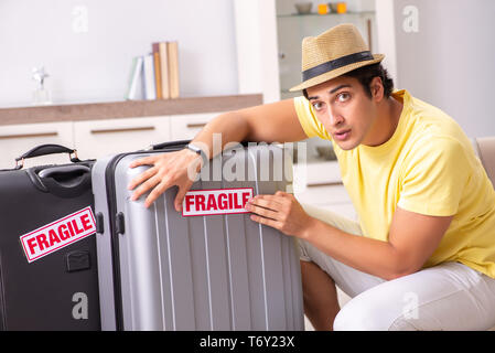 The man going on vacation with fragile suitcases Stock Photo