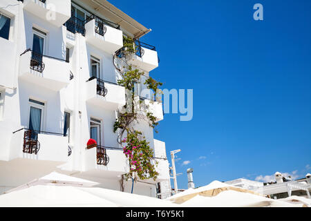 White hotel facade with balcony at blue sky in Bodrum, Turkey Stock Photo