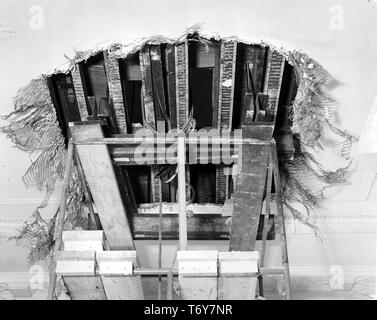 Low angle view of a split beam in the White House lobby's ceiling, discovered during President Truman's White House Reconstruction, Washington, District of Columbia, January 25, 1950. Image courtesy National Archives. () Stock Photo