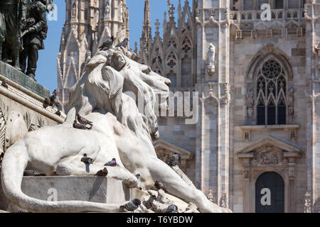 Lion statue and cathedral in Milan Stock Photo
