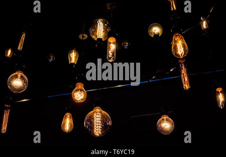 Reproduction vintage Edison light bulbs with exposed spiral filaments are pictured, Sept. 6, 2017, at Campesino coffee shop in Houston, Texas. Stock Photo