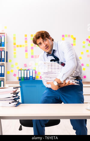 Young employee suffering from excessive work Stock Photo
