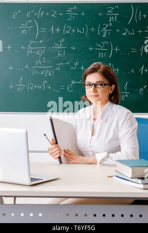 Female math teacher in front of the chalkboard Stock Photo