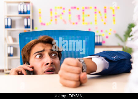 Young employee suffering from excessive work Stock Photo