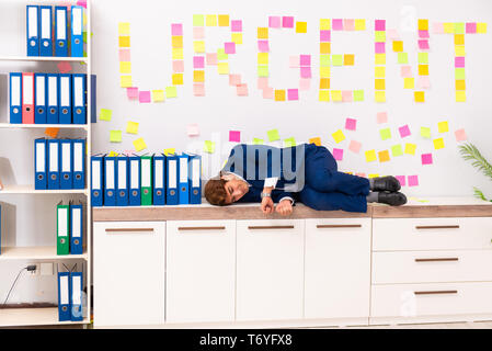 Young employee suffering from excessive work Stock Photo