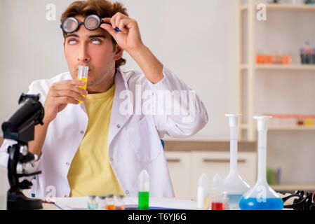 Funny crazy chemist doing experiments and tests Stock Photo