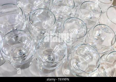 lot of blurred empty glasses on reception party table Stock Photo