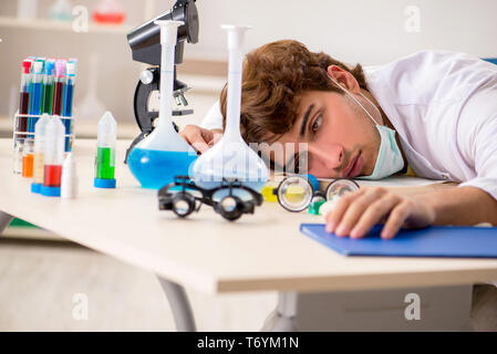 Funny crazy chemist doing experiments and tests Stock Photo