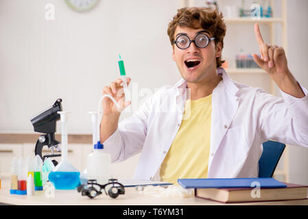 Funny crazy chemist doing experiments and tests Stock Photo