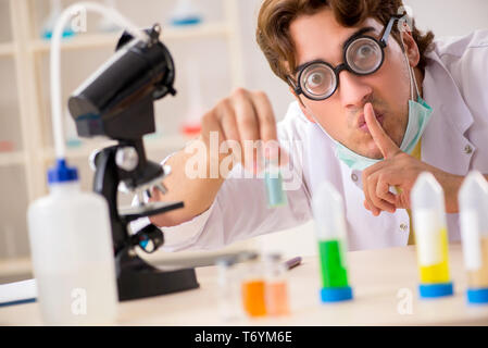 Funny crazy chemist doing experiments and tests Stock Photo