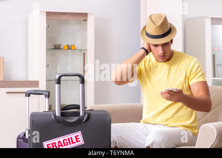 Man going on vacation with fragile suitcases Stock Photo