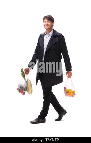 Young handsome man with vegatables in shopping concept Stock Photo