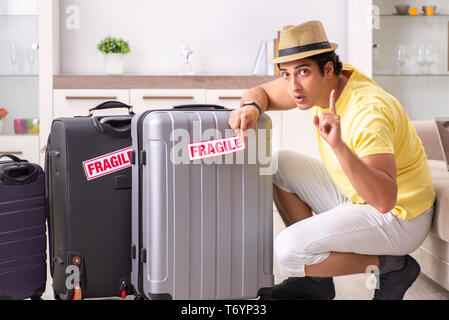 Man going on vacation with fragile suitcases Stock Photo