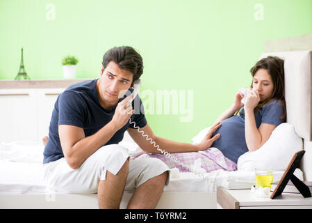 The young husband looking after his pregnant wife Stock Photo