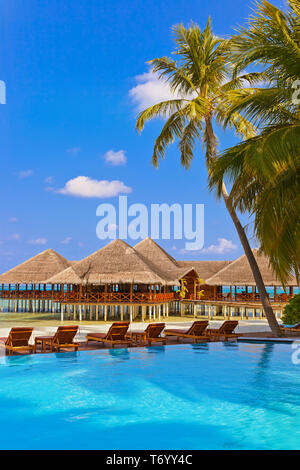 Pool and cafe on Maldives beach Stock Photo