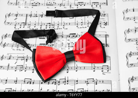 Red bow tie on music sheet Stock Photo
