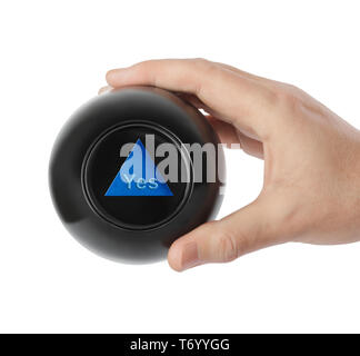 Magic ball with prediction Yes in hand Stock Photo