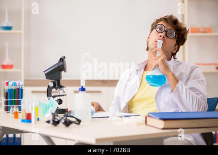 Funny crazy chemist doing experiments and tests Stock Photo