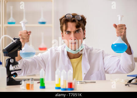 Funny crazy chemist doing experiments and tests Stock Photo
