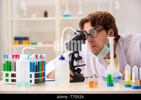 Funny crazy chemist doing experiments and tests Stock Photo