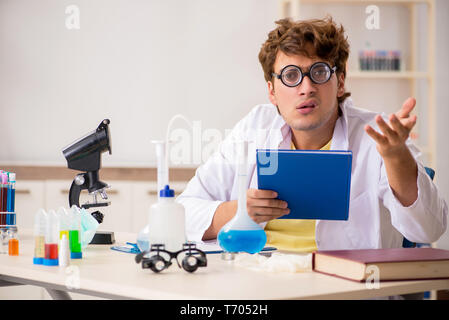 Funny crazy chemist doing experiments and tests Stock Photo