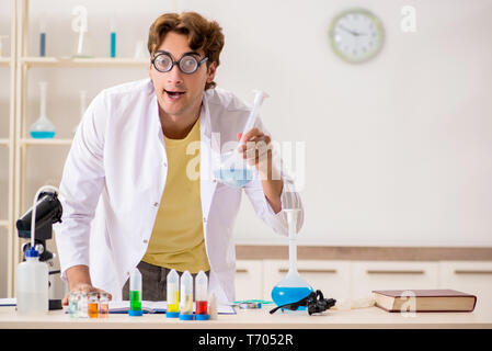 Funny crazy chemist doing experiments and tests Stock Photo