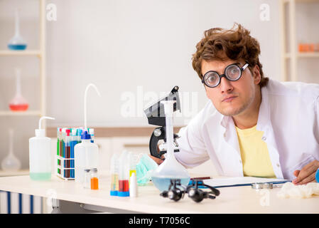 Funny crazy chemist doing experiments and tests Stock Photo